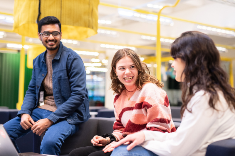 Students chatting at a table at university