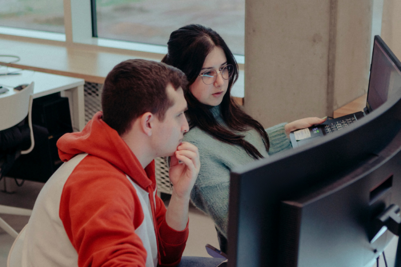 Two students sitting in front of a computer screen