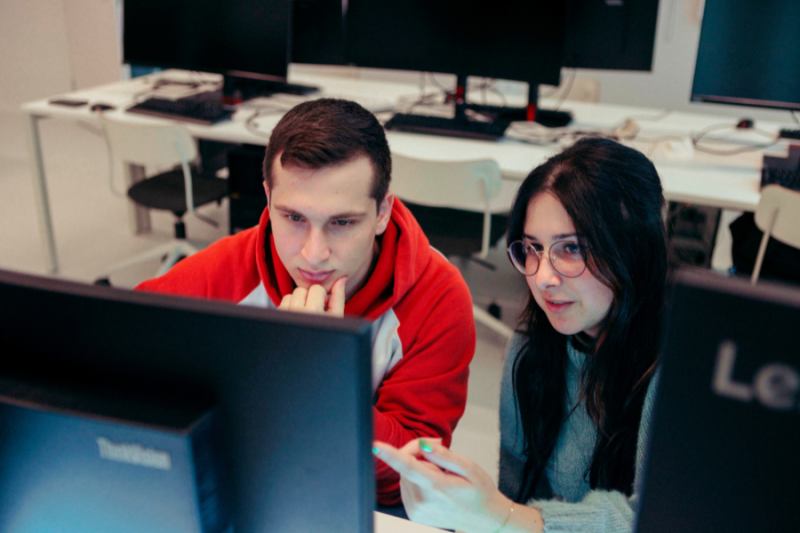 Two students looking at a computer screen